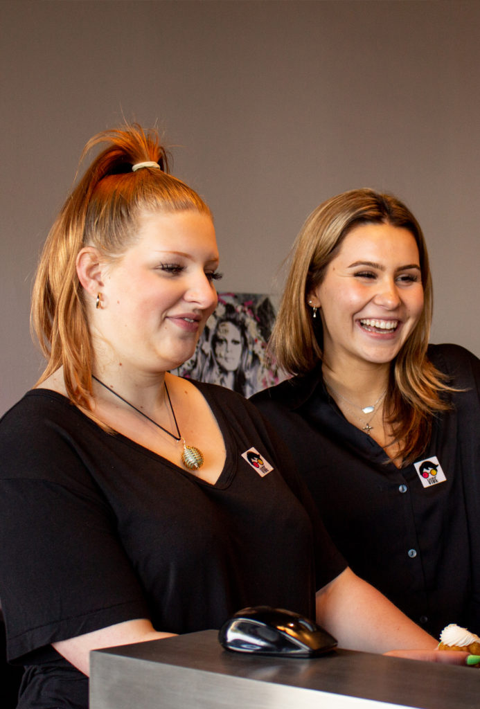 two employees of vibe salon smiling